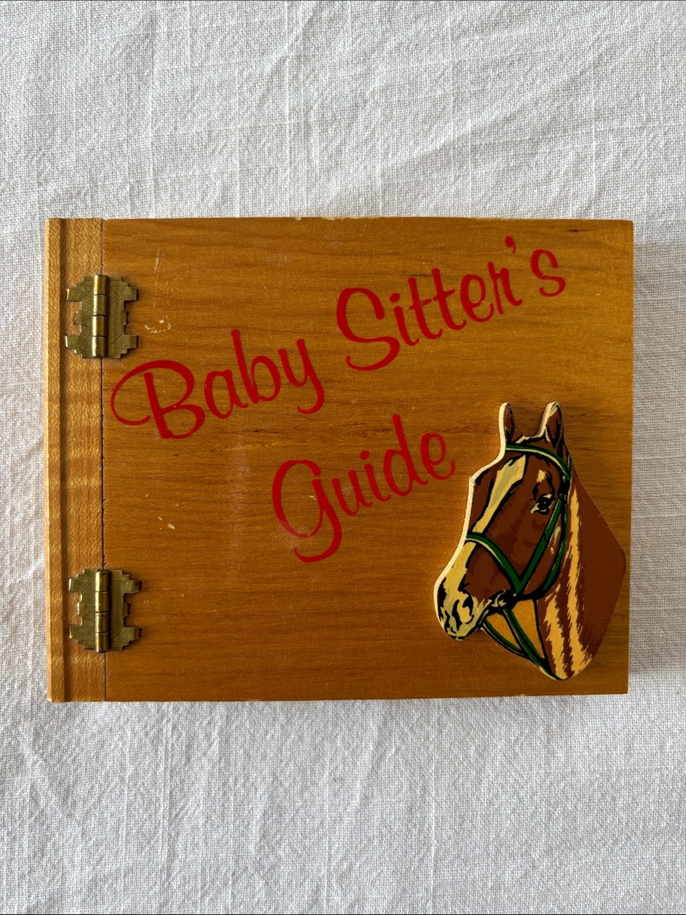 Vintage Baby Sitter’s  Guide, wood cover w/horse, 1 sheet of family info